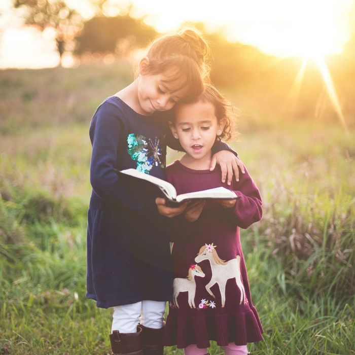 two young girls reading bible two young girls reading bible