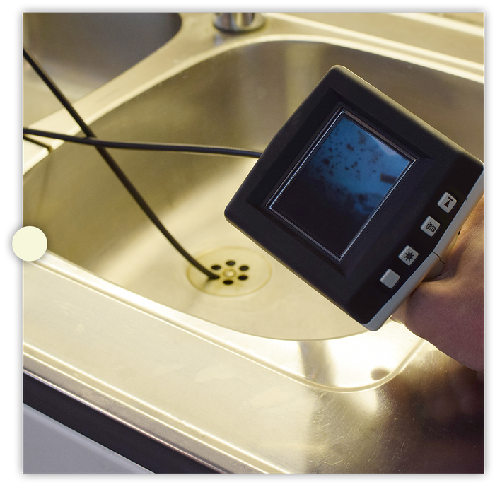 using a snake camera to view inside a sink drain