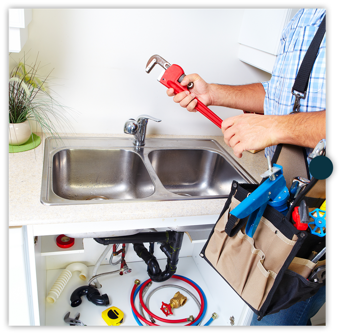 plumber holding wrench and preparing to work on a kitchen sink