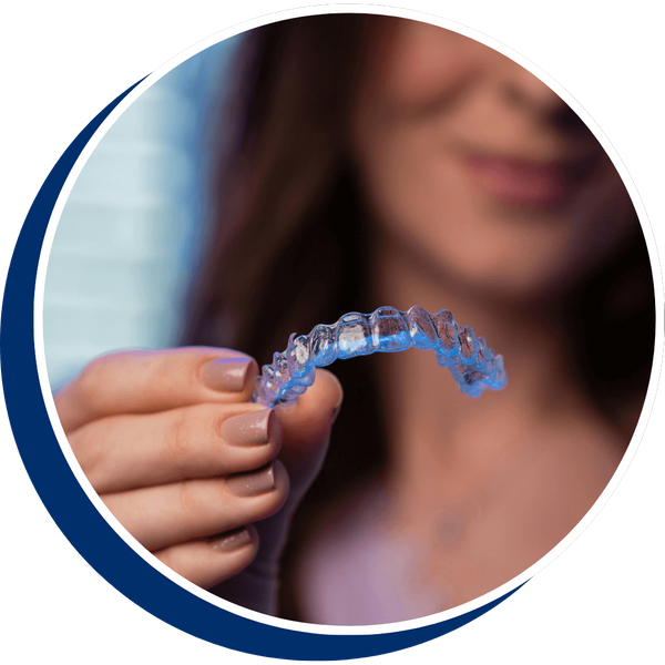 woman holding clear aligners woman holding clear aligners