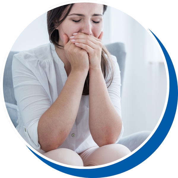 a woman holding her mouth in pain Emergency Dentistry Services Redesign (4).png