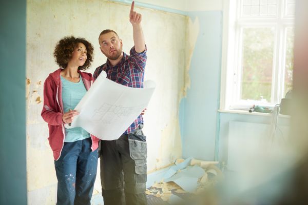 Man talking to a woman, pointing at something. 