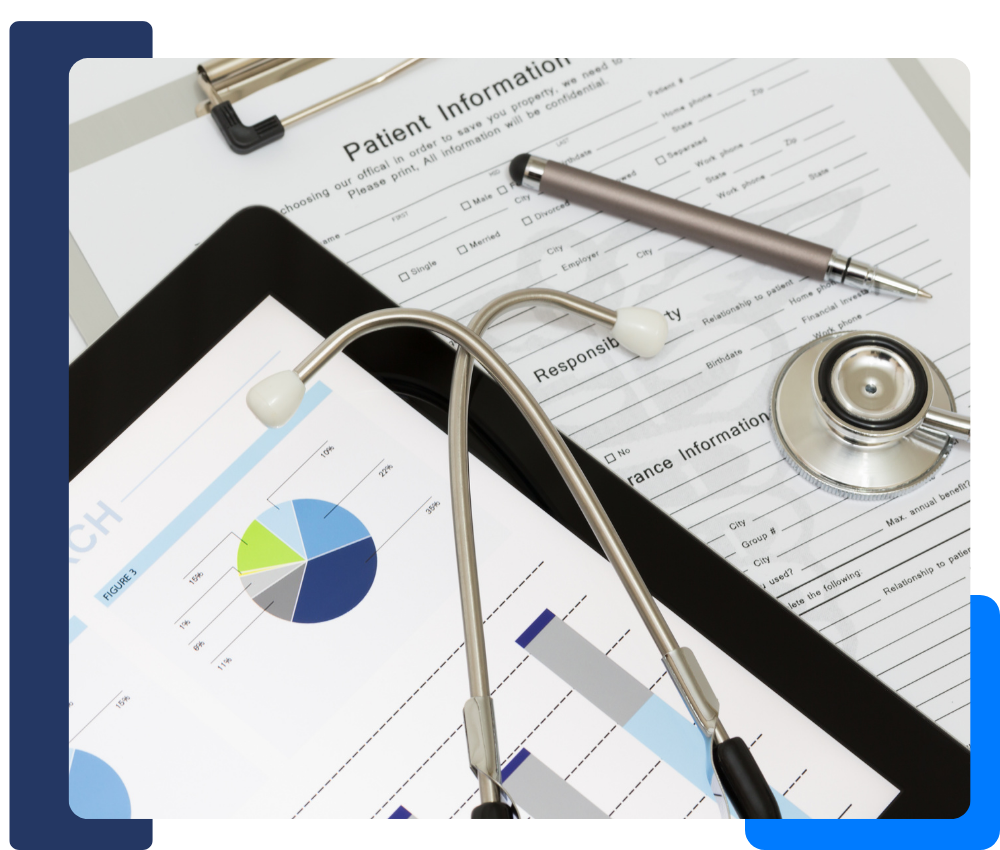 image of healthcare paperwork and a tablet with graphs on it, with a stethoscope on top of both