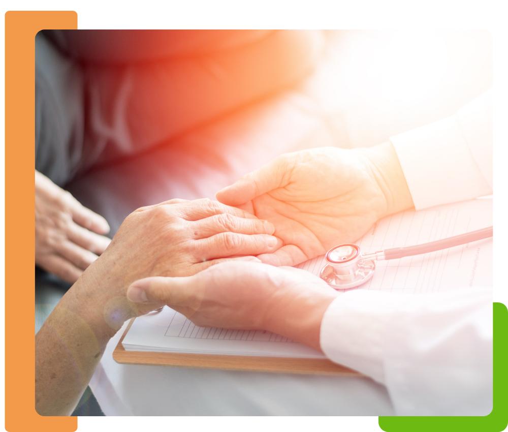 doctor holding the hand of an older woman