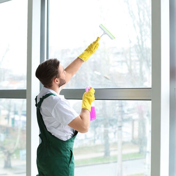 cleaning a window inside a business