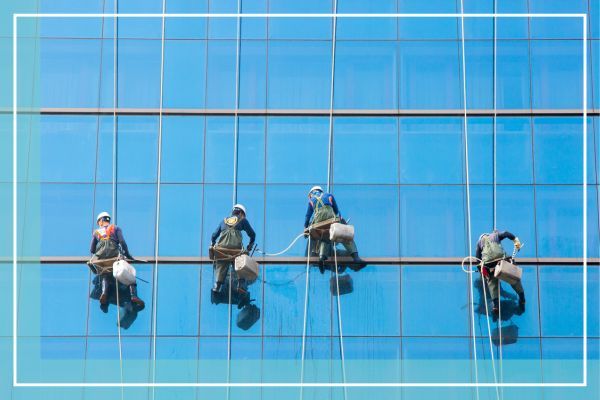 workers washing windows of a tall building