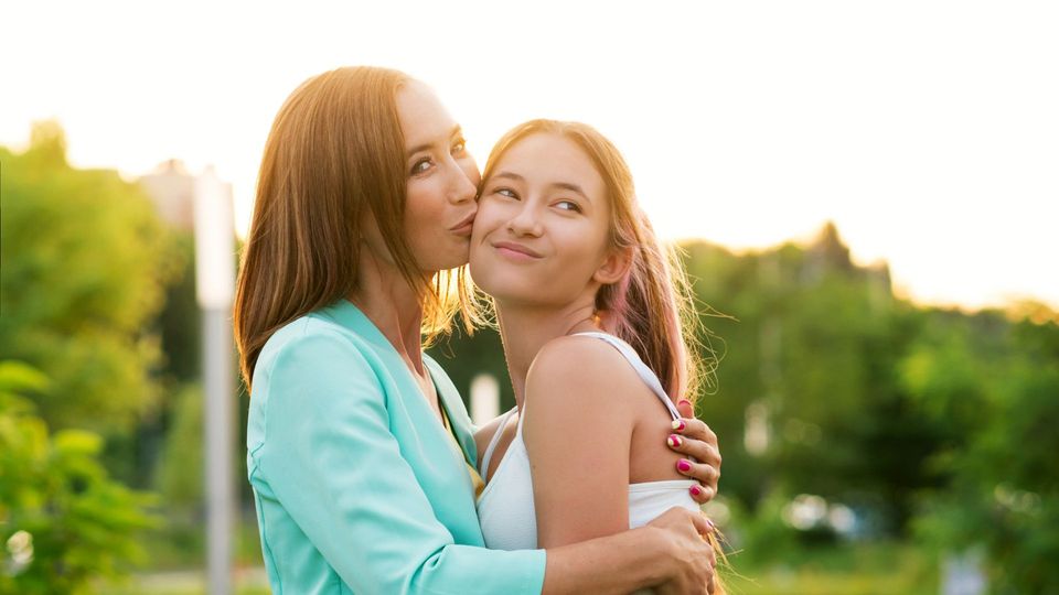 mother hugging daughter