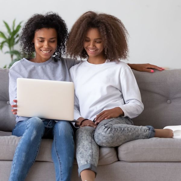 mother and teen daughter looking at computer