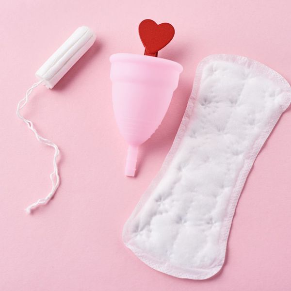 Product photo of a tampon, diva cup, and menstrual pad