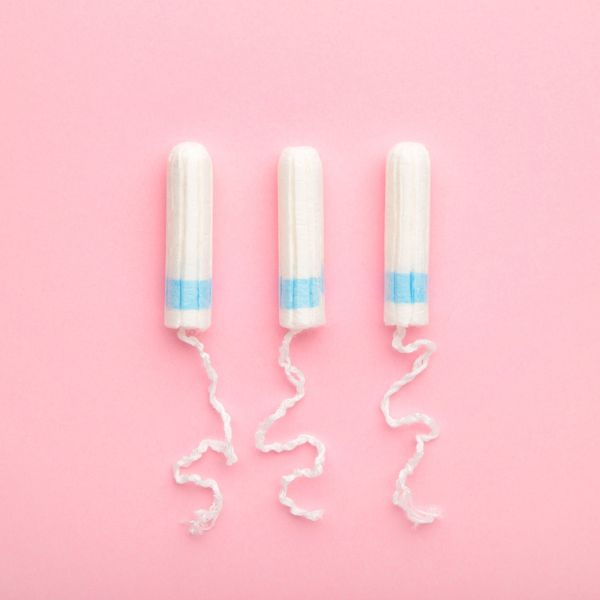 three tampons on pink background