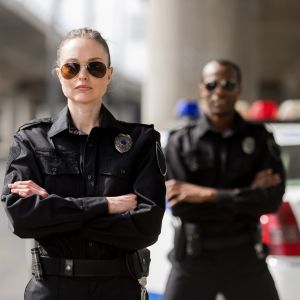 two police officers with arms crossed