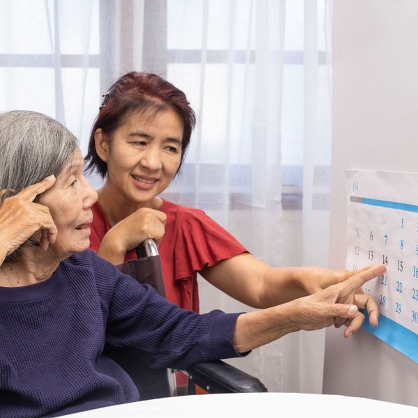 caregiver and patient pointing to calendar 