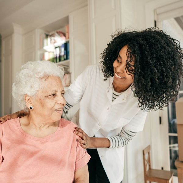 An image of a young woman helping an older woman.