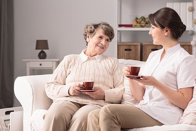 A happy resident with her caregiver