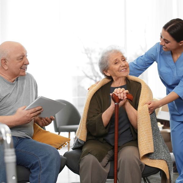 elderly couple with caregiver 