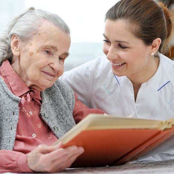 caregiver reading with a woman