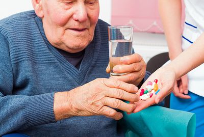 Image of a man taking his medication