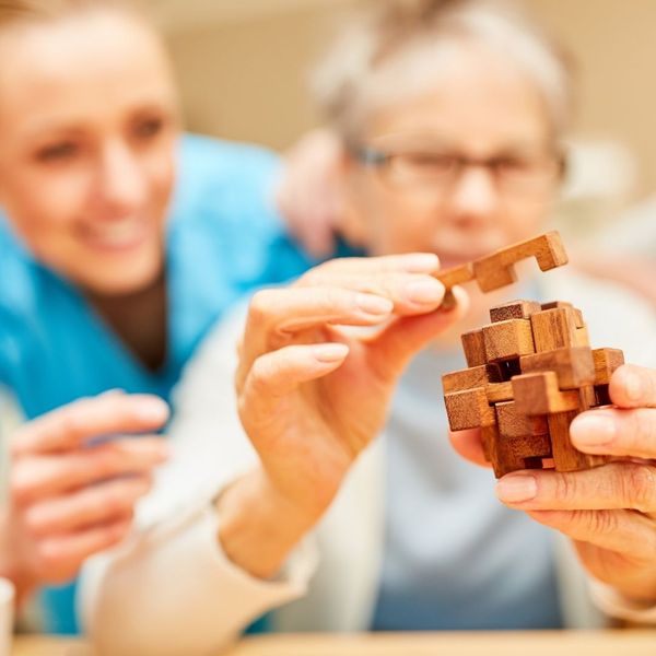 patient doing a puzzle with help