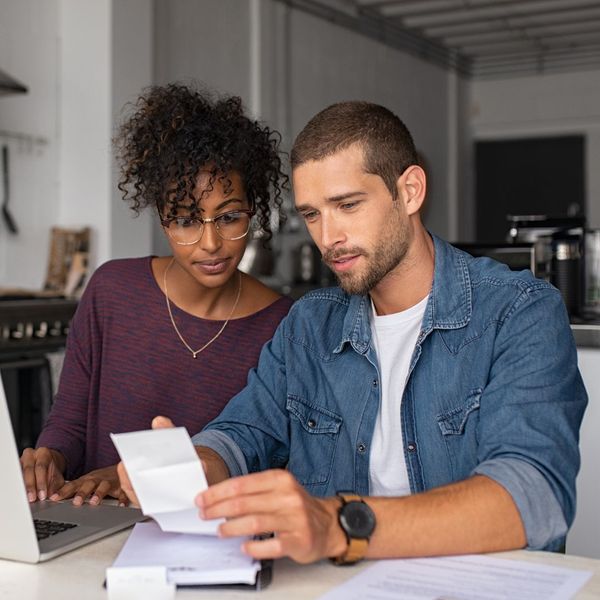 man and woman looking at reciept