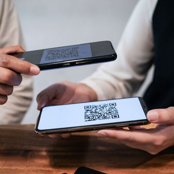 Person scanning a QR code from another person's phone. 