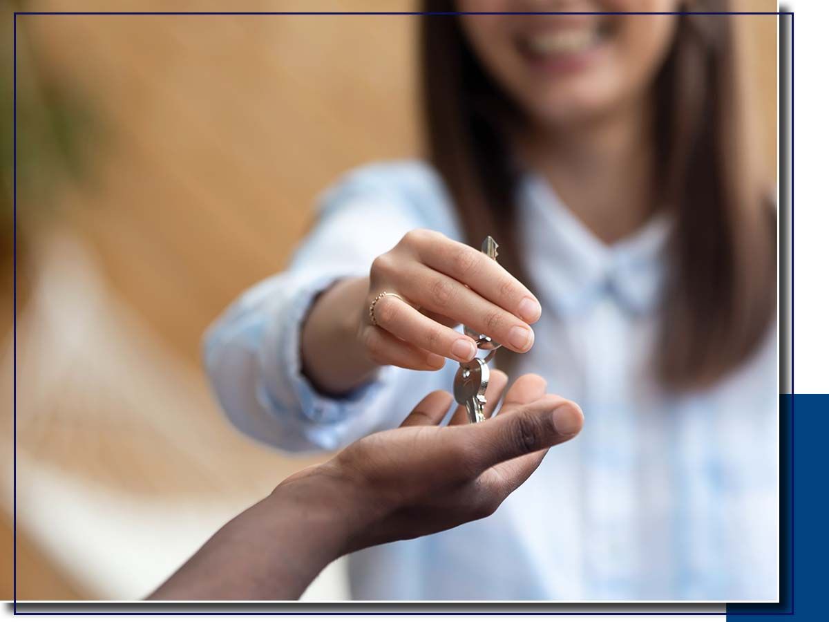 agent handing house keys over to new owner