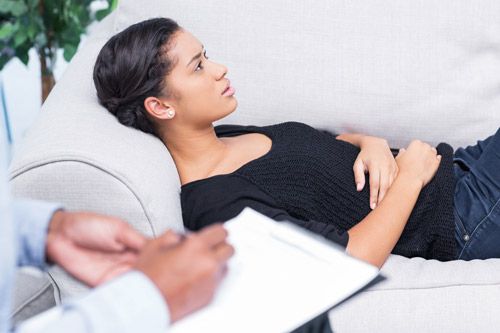 young woman laying on therapy couch