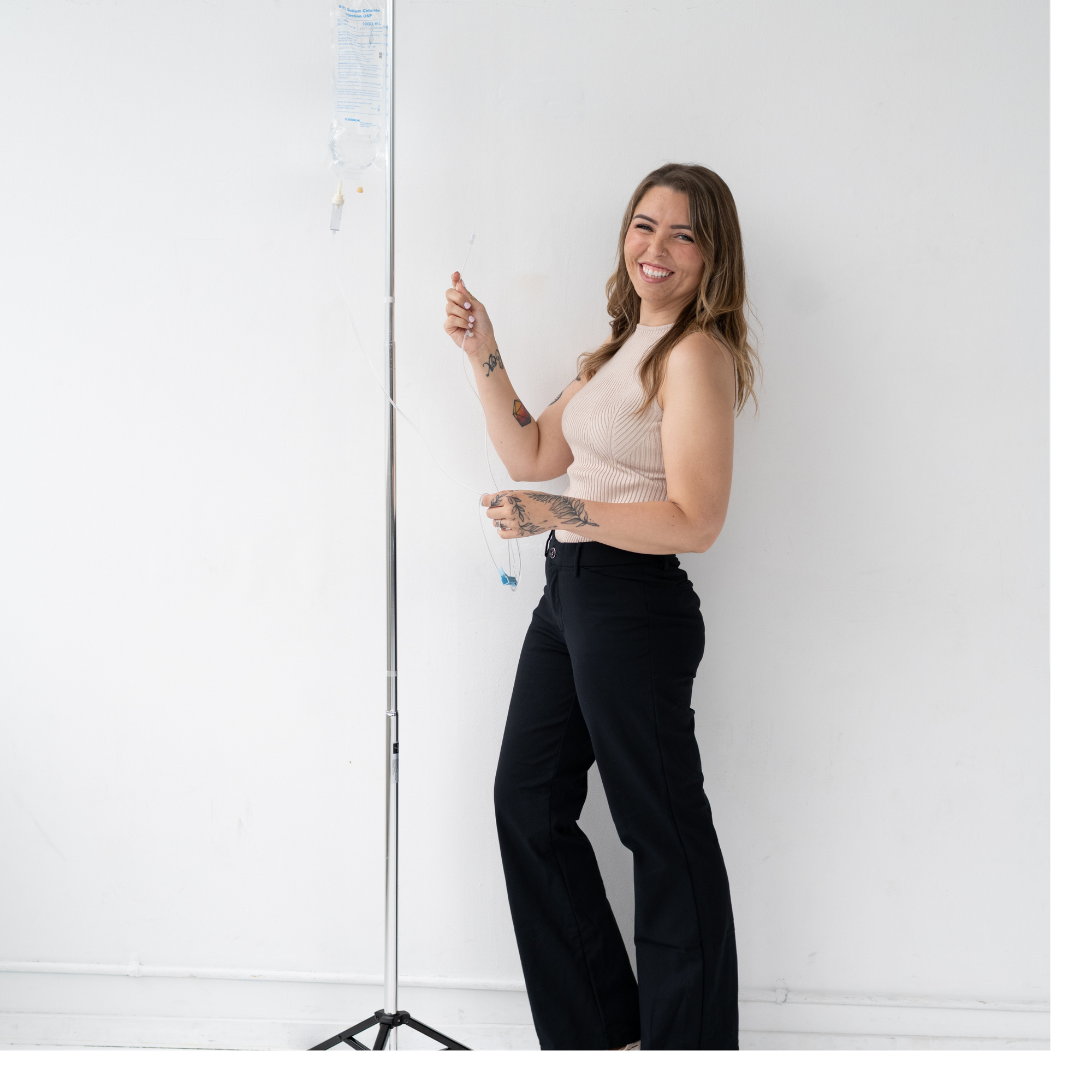 woman holding an IV pole and tube. 