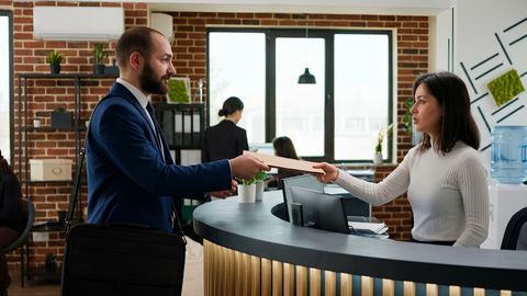 A woman being served papers.