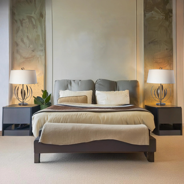 a light bedroom with two table lamps that have leaves branching up from the stem