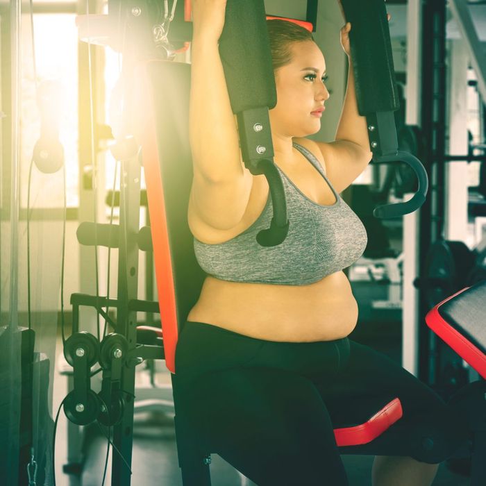 Bigger woman working out at gym