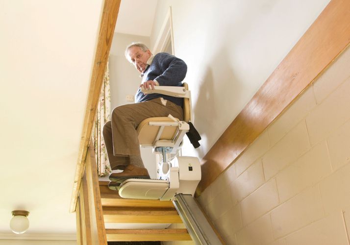 elderly man using stair lift