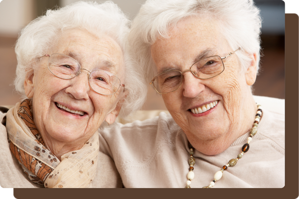 two older woman embracing and smiling together two older woman embracing and smiling together