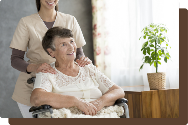 caregiver standing with older woman in a wheelchair caregiver standing with older woman in a wheelchair
