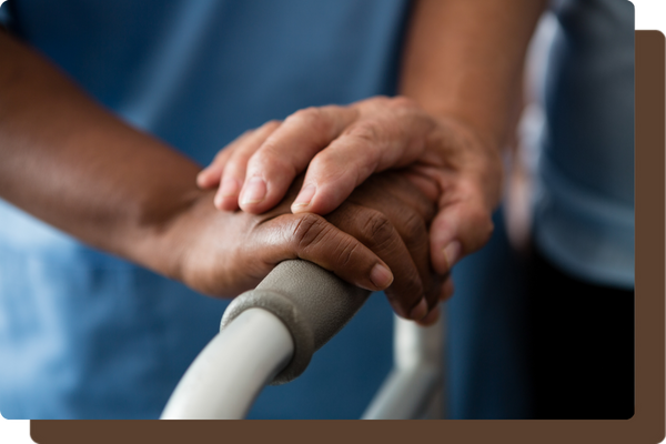 caregiver and older person's hand resting on a walker caregiver and older person's hand resting on a walker