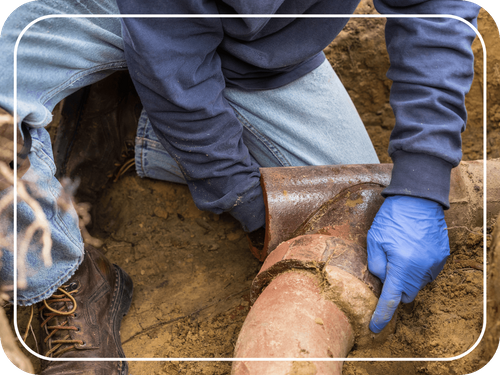 man working on sewer pipe