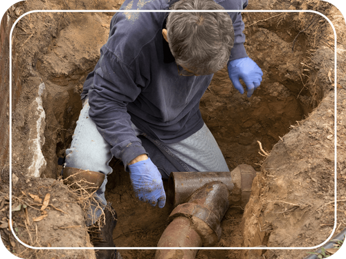 man working on sewer pipe