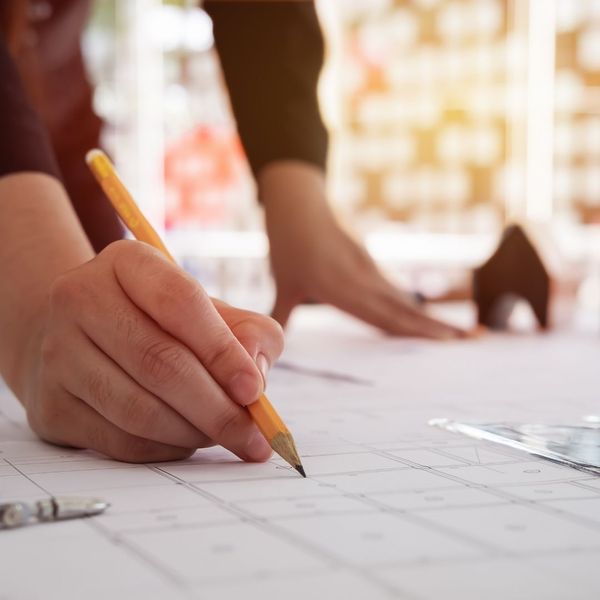 expert specialist holding pencil to paper expert specialist holding pencil to paper