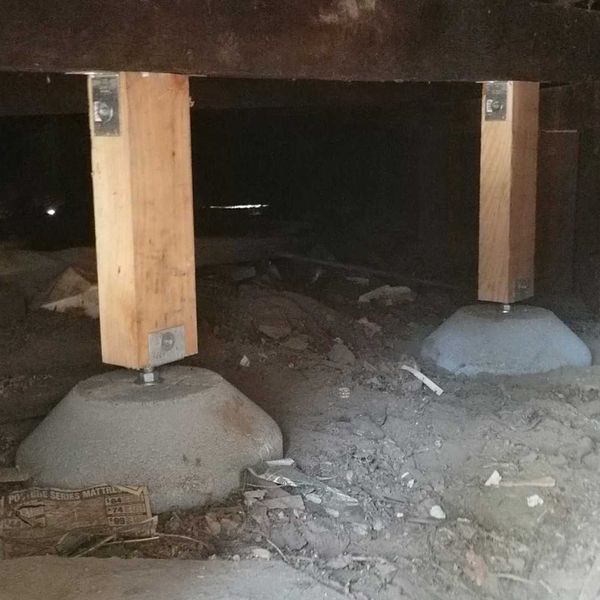 Steel structural supports used in earthquake retrofitting and foundation repair.