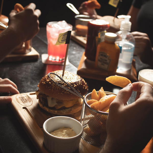 Gourmet burger with fries and drinks in a cozy setting