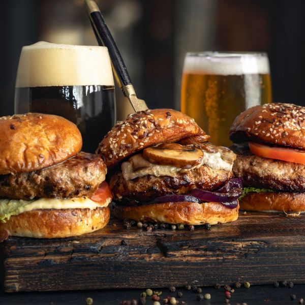 Trio of burgers with beer.