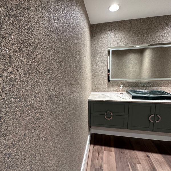 Bathroom with a mirror and gray wallpaper