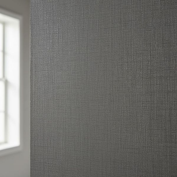 A detailed, square photo highlighting the natural texture of sophisticated gray grasscloth wallpaper.