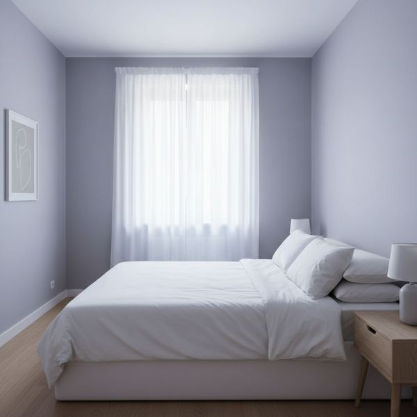 Serene bedroom with cool-toned walls creating a restful and relaxing environment.