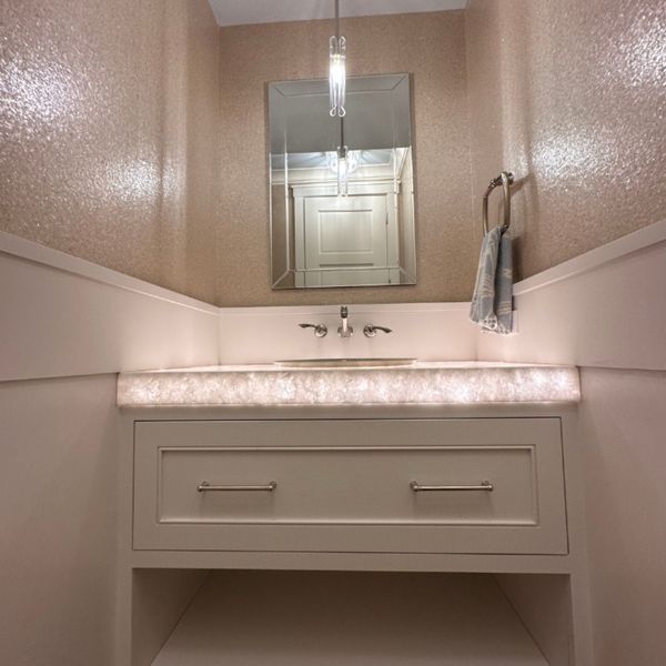 Small bathroom with a mirror and lighting