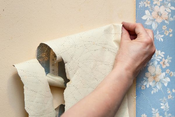 person removing wallpaper