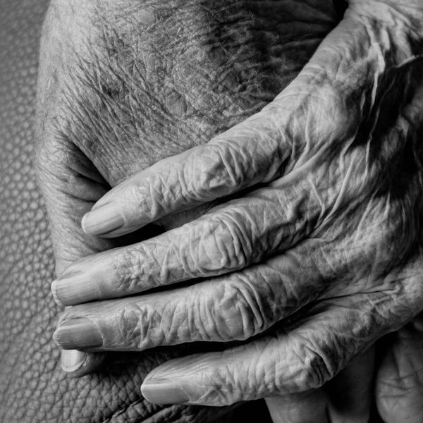 an elderly couple holding hands
