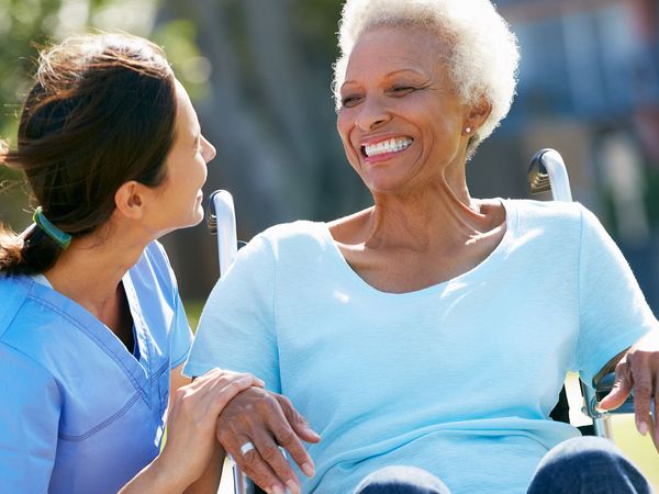 Image of a nurse talking to a patient happily