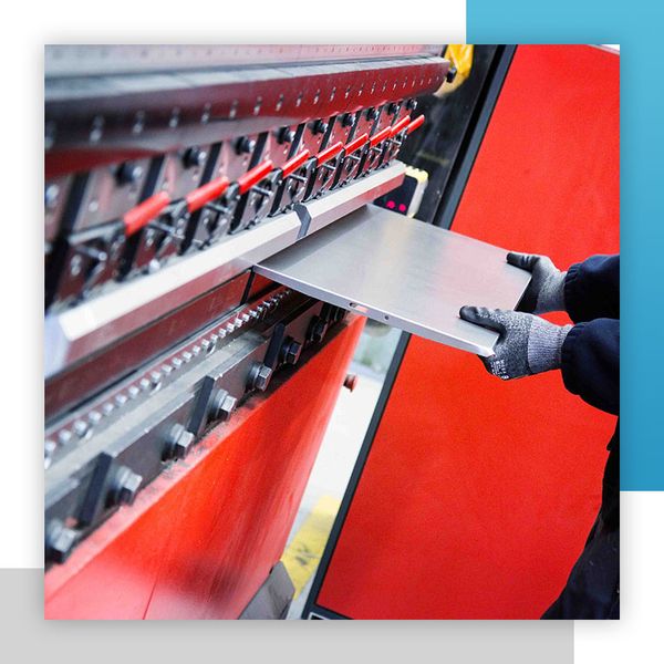 Man putting metal sheet in machine