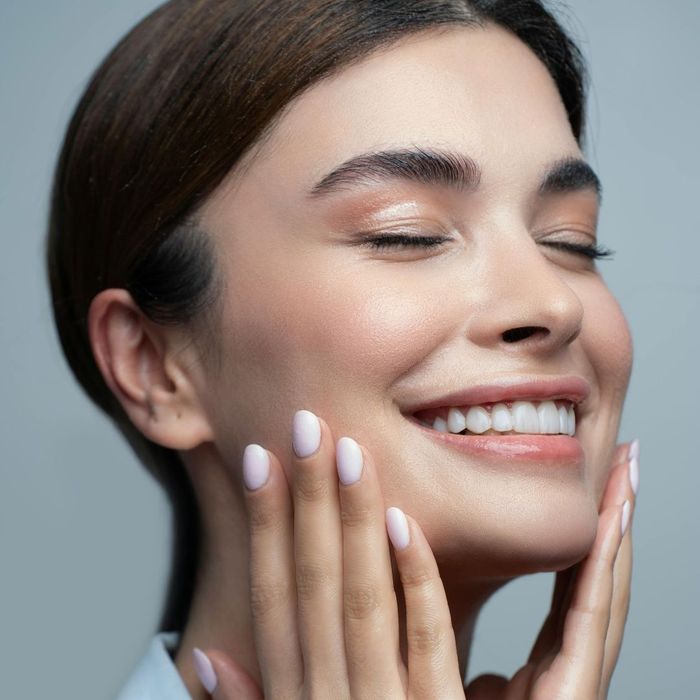 woman touching her own face