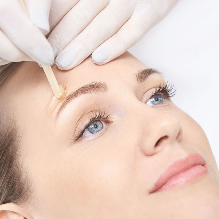 woman having her eyebrows waxed